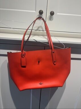Coach Bright Orange Pebbled Leather Tote. Used only once. Small stain on bottom.